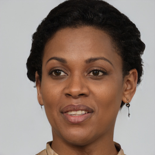 Joyful black young-adult female with short  brown hair and brown eyes