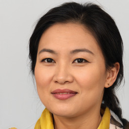 Joyful asian adult female with medium  brown hair and brown eyes