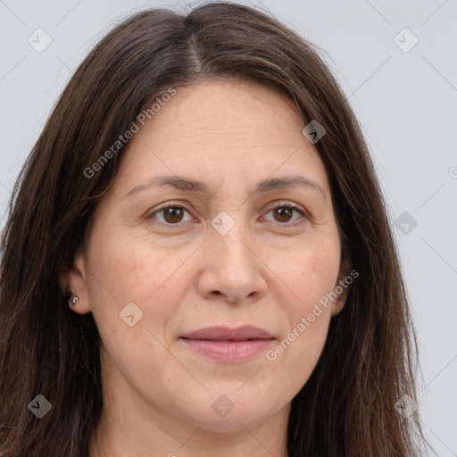 Joyful white adult female with long  brown hair and brown eyes