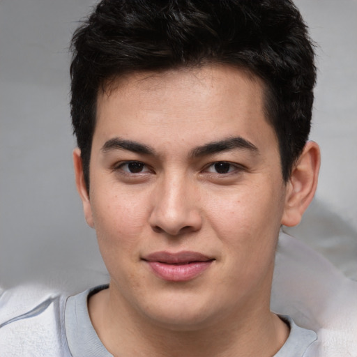 Joyful asian young-adult male with short  brown hair and brown eyes