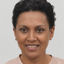 Joyful black adult female with short  black hair and brown eyes