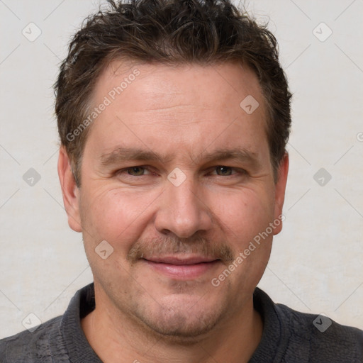 Joyful white adult male with short  brown hair and grey eyes