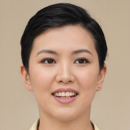 Joyful asian young-adult female with short  black hair and brown eyes