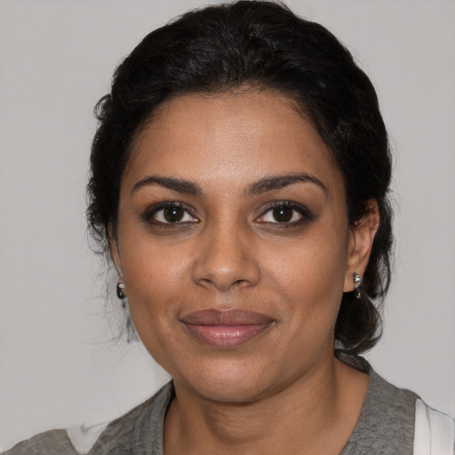 Joyful black young-adult female with medium  brown hair and brown eyes