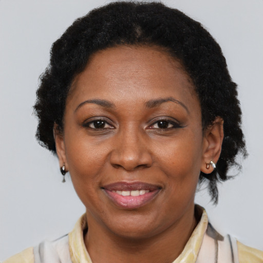 Joyful latino adult female with short  brown hair and brown eyes