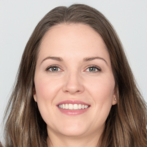 Joyful white young-adult female with long  brown hair and brown eyes