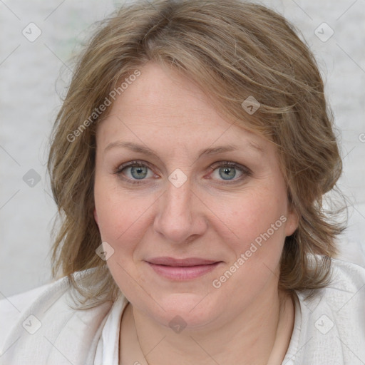 Joyful white adult female with medium  brown hair and blue eyes