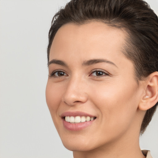 Joyful white young-adult female with short  brown hair and brown eyes