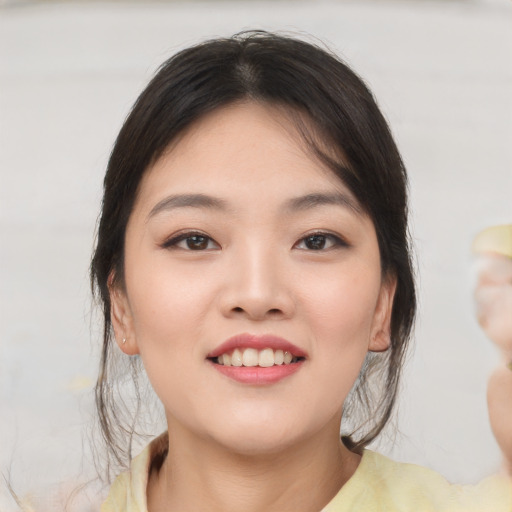 Joyful asian young-adult female with medium  brown hair and brown eyes