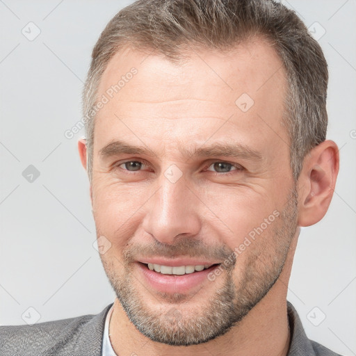 Joyful white adult male with short  brown hair and grey eyes