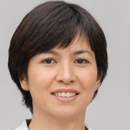 Joyful white adult female with medium  brown hair and brown eyes