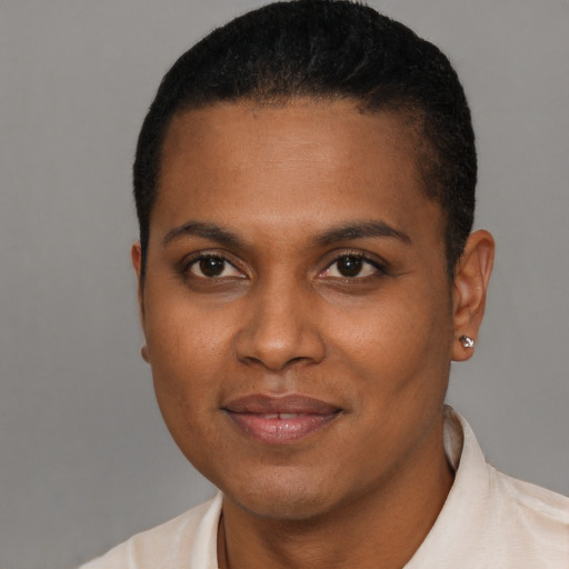 Joyful black young-adult female with short  black hair and brown eyes