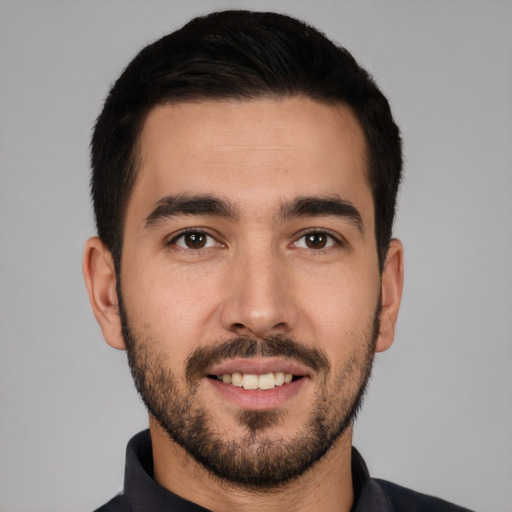 Joyful white young-adult male with short  black hair and brown eyes