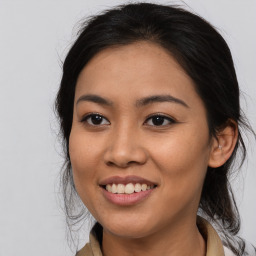 Joyful latino young-adult female with medium  brown hair and brown eyes