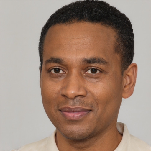 Joyful latino adult male with short  black hair and brown eyes