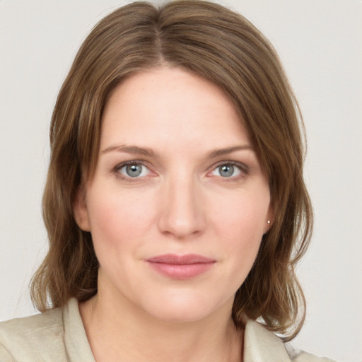 Joyful white young-adult female with medium  brown hair and green eyes