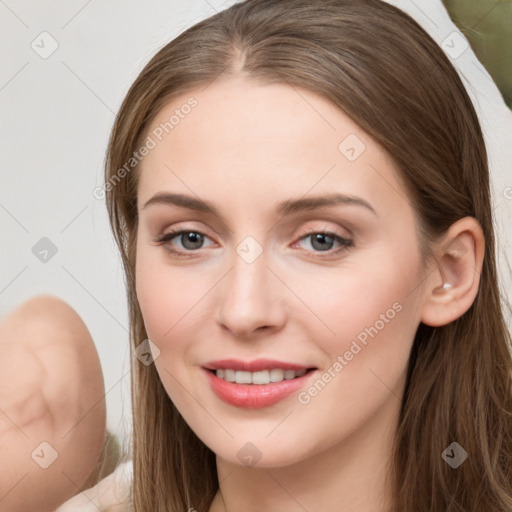 Joyful white young-adult female with long  brown hair and blue eyes