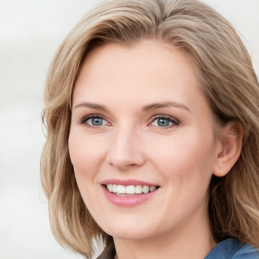 Joyful white young-adult female with medium  brown hair and blue eyes