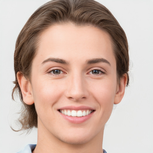 Joyful white young-adult female with short  brown hair and grey eyes