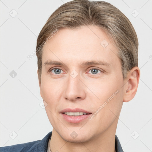 Joyful white adult male with short  brown hair and grey eyes