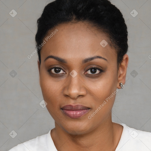 Joyful black young-adult female with short  black hair and brown eyes