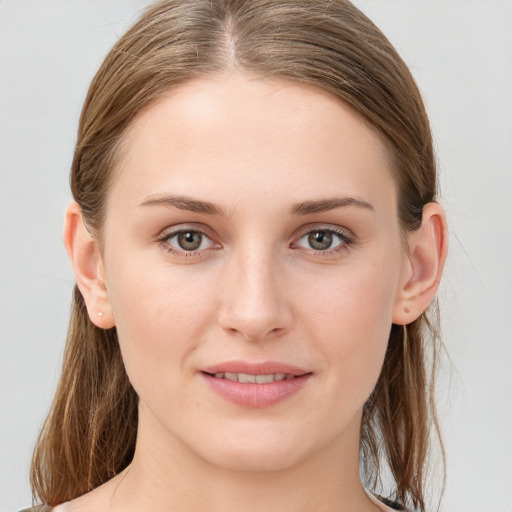 Joyful white young-adult female with long  brown hair and blue eyes