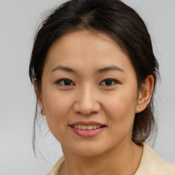 Joyful asian young-adult female with medium  brown hair and brown eyes