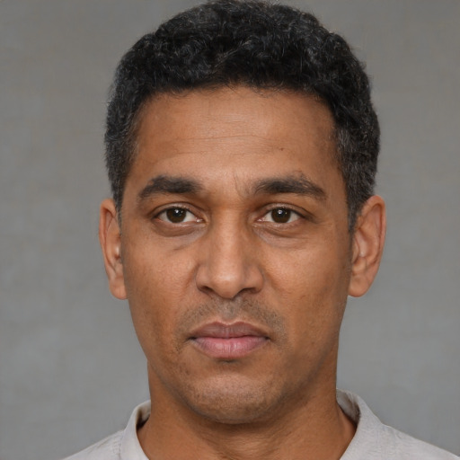Neutral black adult male with short  black hair and brown eyes