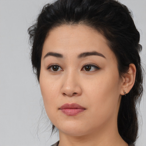 Joyful asian young-adult female with medium  brown hair and brown eyes