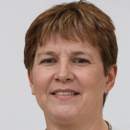 Joyful white adult female with short  brown hair and grey eyes