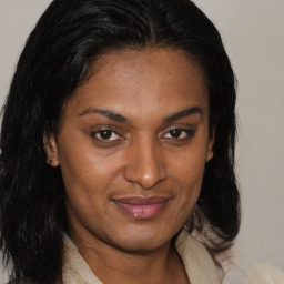 Joyful black young-adult female with medium  brown hair and brown eyes