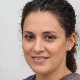 Joyful white adult female with medium  brown hair and brown eyes