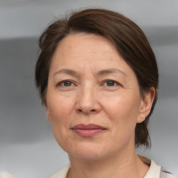 Joyful white adult female with medium  brown hair and brown eyes