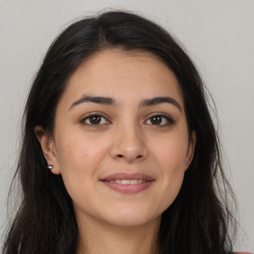 Joyful white young-adult female with long  brown hair and brown eyes