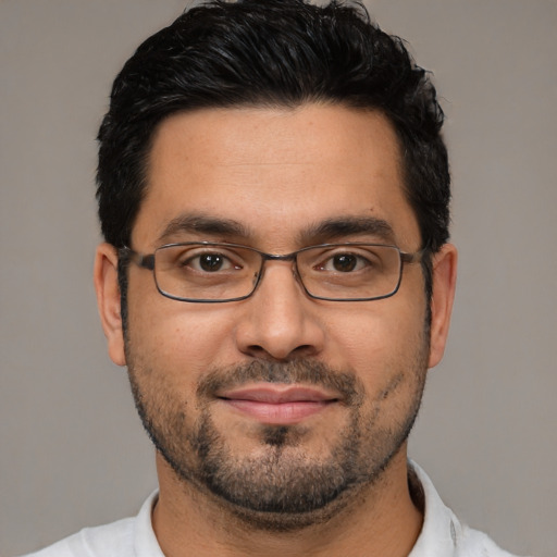 Joyful white adult male with short  black hair and brown eyes