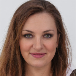 Joyful white young-adult female with long  brown hair and green eyes