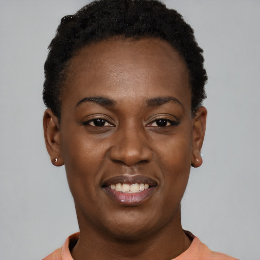 Joyful black young-adult female with short  black hair and brown eyes