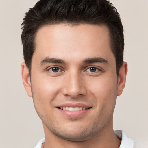 Joyful white young-adult male with short  brown hair and brown eyes