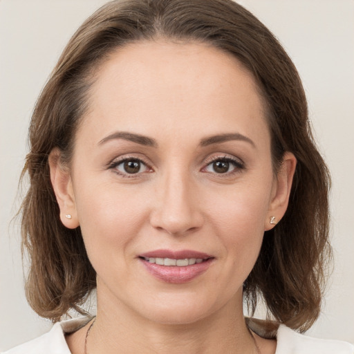 Joyful white young-adult female with medium  brown hair and grey eyes