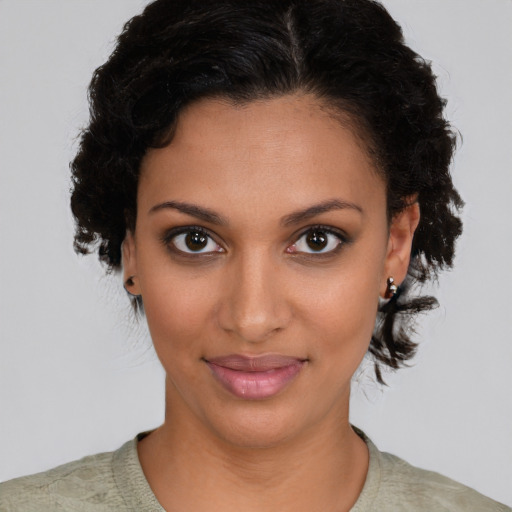 Joyful black young-adult female with medium  brown hair and brown eyes