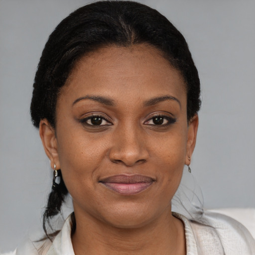 Joyful black young-adult female with short  brown hair and brown eyes