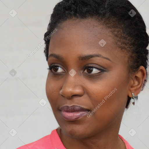 Joyful black young-adult female with short  brown hair and brown eyes