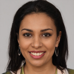 Joyful latino young-adult female with long  brown hair and brown eyes