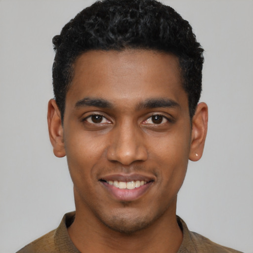 Joyful black young-adult male with short  black hair and brown eyes