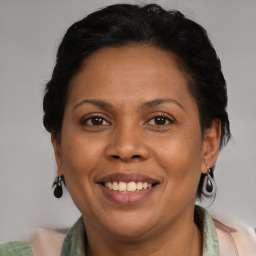 Joyful latino adult female with medium  brown hair and brown eyes