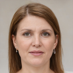 Joyful white adult female with medium  brown hair and grey eyes