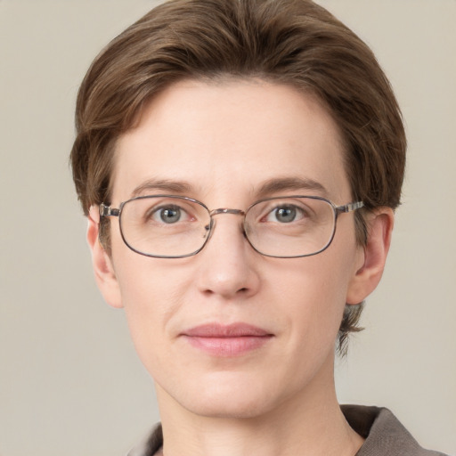 Joyful white adult female with short  brown hair and grey eyes