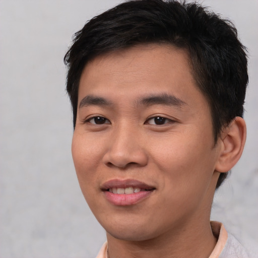 Joyful asian young-adult male with short  brown hair and brown eyes
