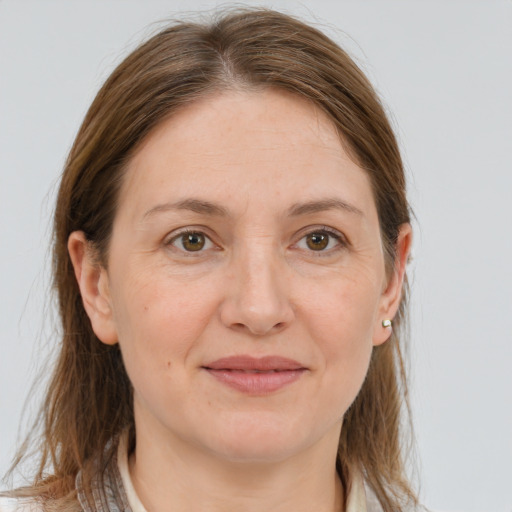 Joyful white adult female with medium  brown hair and grey eyes