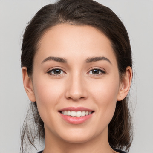 Joyful white young-adult female with medium  brown hair and brown eyes